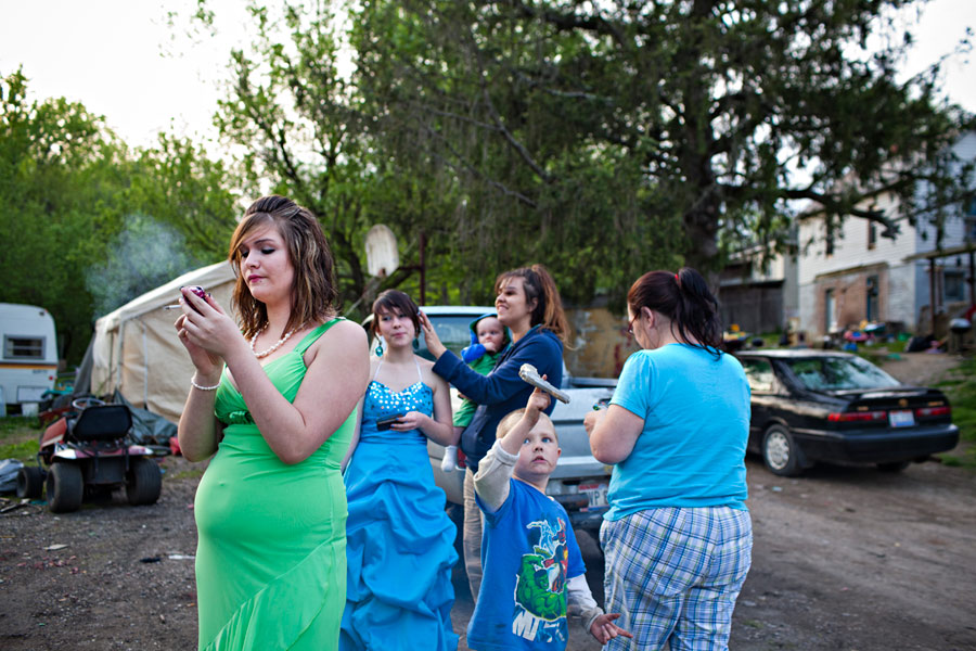 Moments before heading to prom with her friend Nikki Branhart, 17, Jameska steps away from the excitement of her cousins and her mother, right, to continue arranging her plans for afterwards. Her hopes were to cut her time short at the prom and convince a boy to come over and hang out.